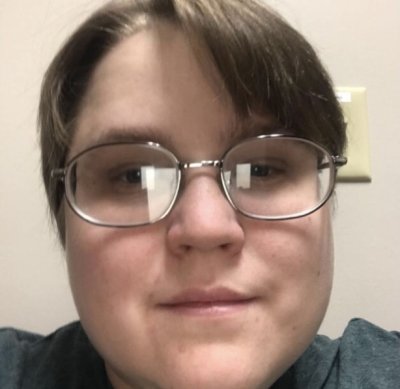 Close up portrait of valuableboy's face with short light brown hair  wearing oval shaped glasses